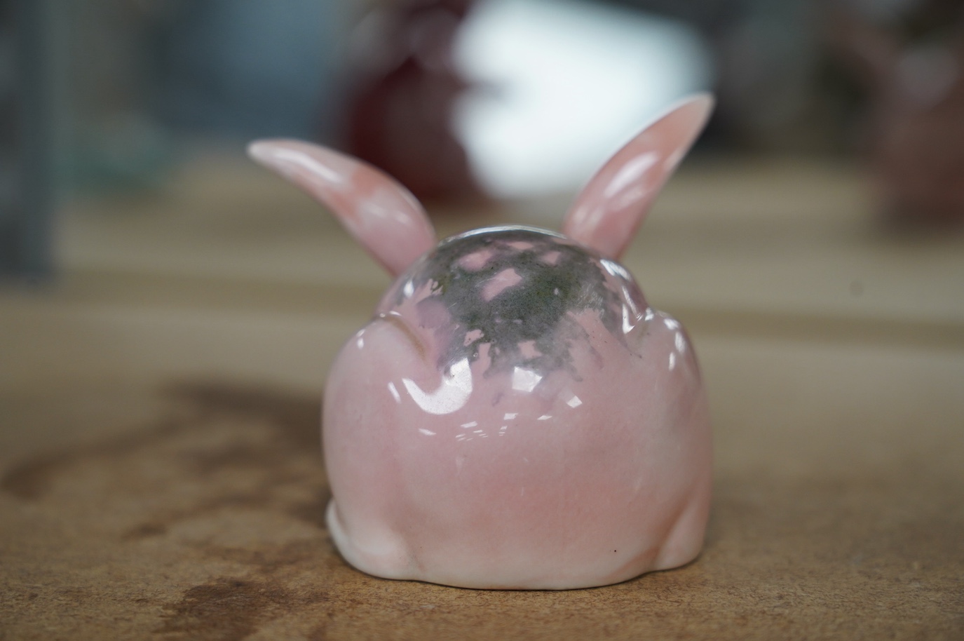 A Bernard Moore pink rabbit with glass eyes, c.1910, signed, 6.5cm. Condition - good